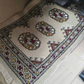 Beige cotton and wool car mat with geometric elephant foot pattern
