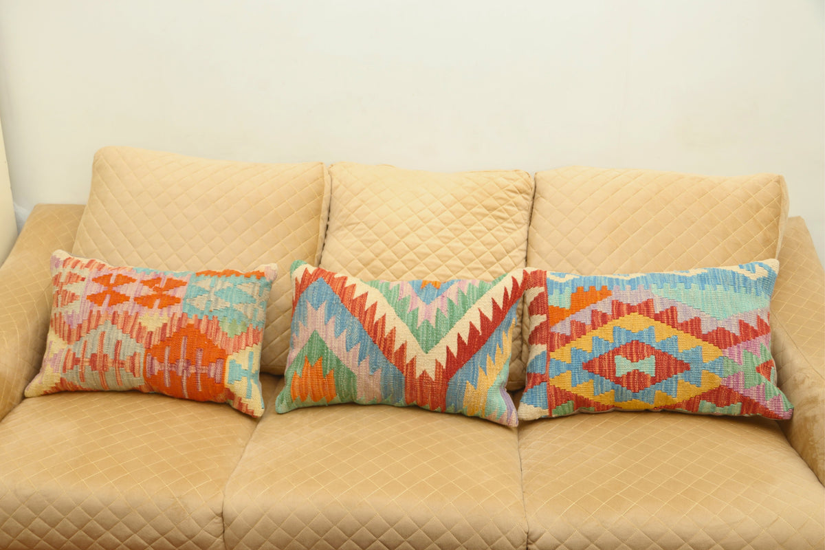 Multicolor geometric wool decorative cushion with a vibrant patterned design for stylish home décor.