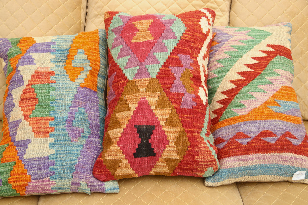 Multicolor geometric wool cushion featuring a vibrant patterned design for luxury home décor.