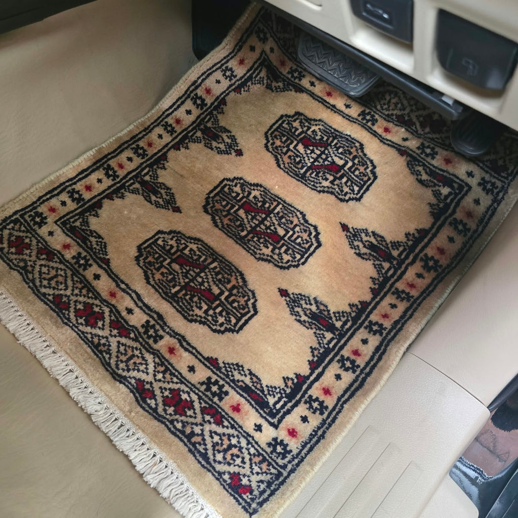Beige cotton wool car mat with black and red geometric elephant foot pattern