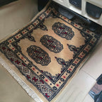 Beige cotton wool car mat with black and red geometric elephant foot pattern
