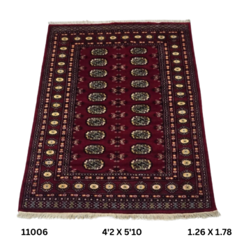 Handmade wool and cotton area rug or runner with repeated geometric Bokhara pattern displayed on floor