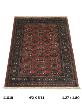 Handmade wool and cotton area rug or runner with repeated geometric Bokhara pattern displayed on floor