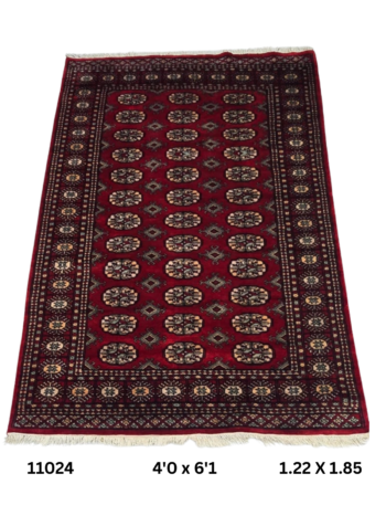 Handmade wool and cotton area rug or runner with repeated geometric Bokhara pattern displayed on floor