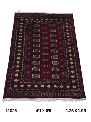 Handmade wool and cotton area rug or runner with repeated geometric Bokhara pattern displayed on floor