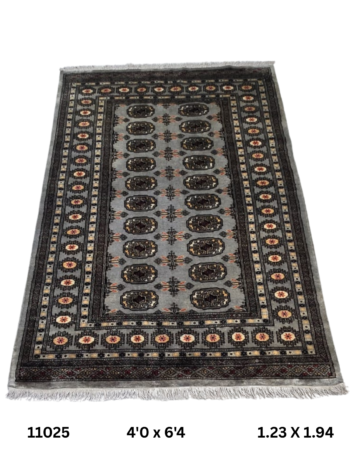 Handmade wool and cotton area rug or runner with repeated geometric Bokhara pattern displayed on floor