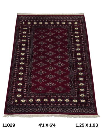 Handmade wool and cotton area rug or runner with repeated geometric Bokhara pattern displayed on floor