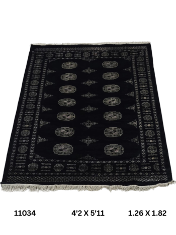 Handmade wool and cotton area rug or runner with repeated geometric Bokhara pattern displayed on floor