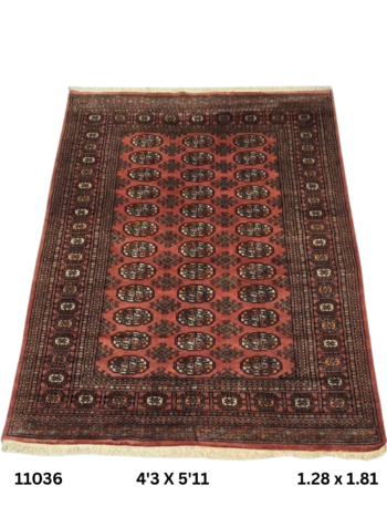 Handmade wool and cotton area rug or runner with repeated geometric Bokhara pattern displayed on floor