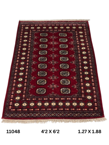 Handmade wool and cotton area rug or runner with repeated geometric Bokhara pattern displayed on floor