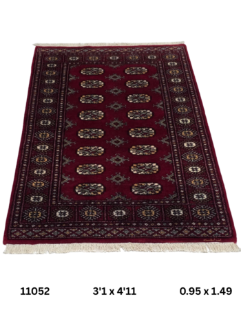Handmade wool and cotton area rug or runner with repeated geometric Bokhara pattern displayed on floor
