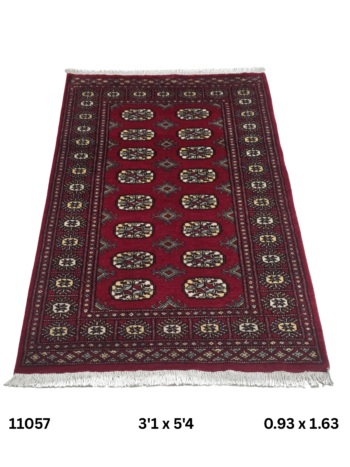 Handmade wool and cotton area rug or runner with repeated geometric Bokhara pattern displayed on floor