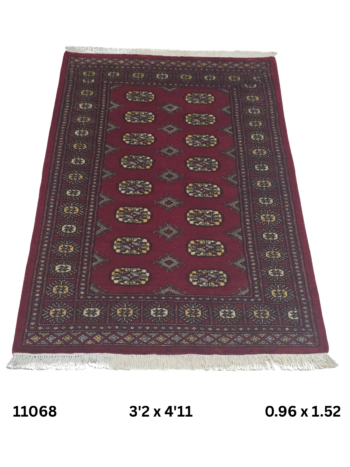 Handmade wool and cotton area rug or runner with repeated geometric Bokhara pattern displayed on floor