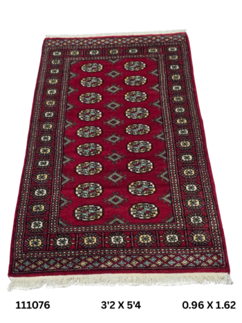 Handmade wool and cotton area rug or runner with repeated geometric Bokhara pattern displayed on floor