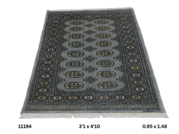 Handmade wool and cotton area rug or runner with repeated geometric Bokhara pattern displayed on floor