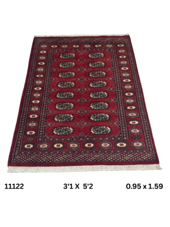 Handmade wool and cotton area rug or runner with repeated geometric Bokhara pattern displayed on floor