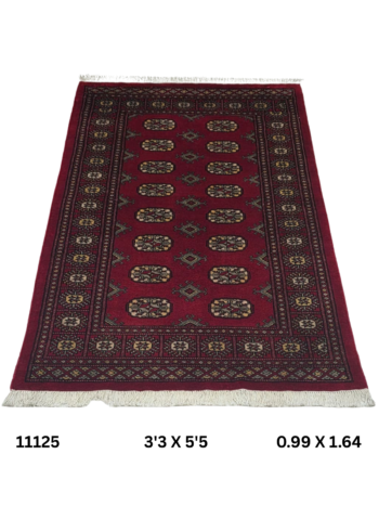 Handmade wool and cotton area rug or runner with repeated geometric Bokhara pattern displayed on floor