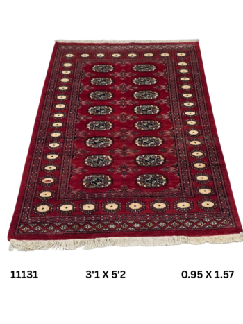 Handmade wool and cotton area rug or runner with repeated geometric Bokhara pattern displayed on floor