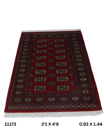 Handmade wool and cotton area rug or runner with repeated geometric Bokhara pattern displayed on floor