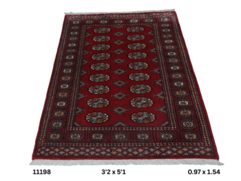 Handmade wool and cotton area rug or runner with repeated geometric Bokhara pattern displayed on floor