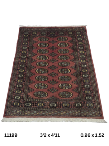 Handmade wool and cotton area rug or runner with repeated geometric Bokhara pattern displayed on floor