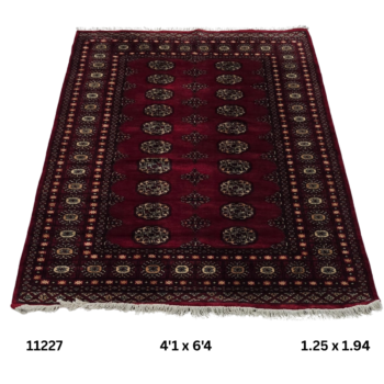 Handmade wool and cotton area rug or runner with repeated geometric Bokhara pattern displayed on floor