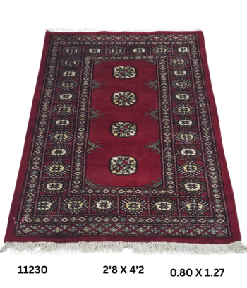 Handmade wool and cotton area rug or runner with repeated geometric Bokhara pattern displayed on floor