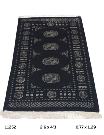 Handmade wool and cotton area rug or runner with repeated geometric Bokhara pattern displayed on floor