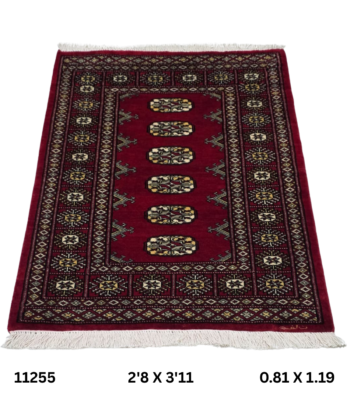 Handmade wool and cotton area rug or runner with repeated geometric Bokhara pattern displayed on floor