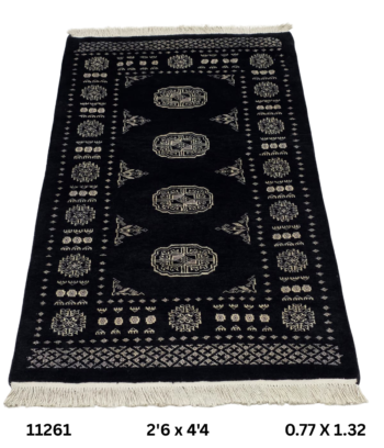 Handmade wool and cotton area rug or runner with repeated geometric Bokhara pattern displayed on floor