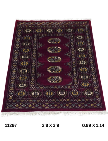 Handmade wool and cotton area rug or runner with repeated geometric Bokhara pattern displayed on floor