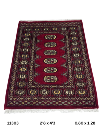 Handmade wool and cotton area rug or runner with repeated geometric Bokhara pattern displayed on floor