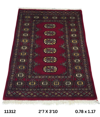 Handmade wool and cotton area rug or runner with repeated geometric Bokhara pattern displayed on floor