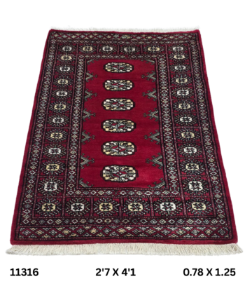 Handmade wool and cotton area rug or runner with repeated geometric Bokhara pattern displayed on floor