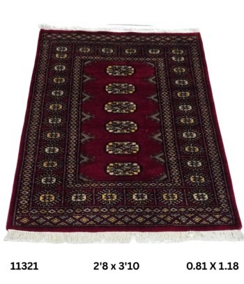 Handmade wool and cotton area rug or runner with repeated geometric Bokhara pattern displayed on floor