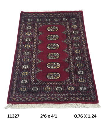 Handmade wool and cotton area rug or runner with repeated geometric Bokhara pattern displayed on floor