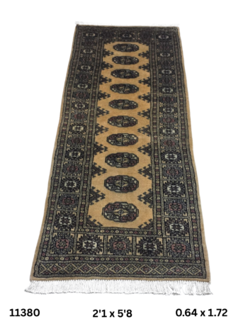 Handmade wool and cotton area rug or runner with repeated geometric Bokhara pattern displayed on floor