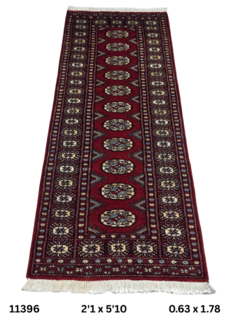 Handmade wool and cotton area rug or runner with repeated geometric Bokhara pattern displayed on floor