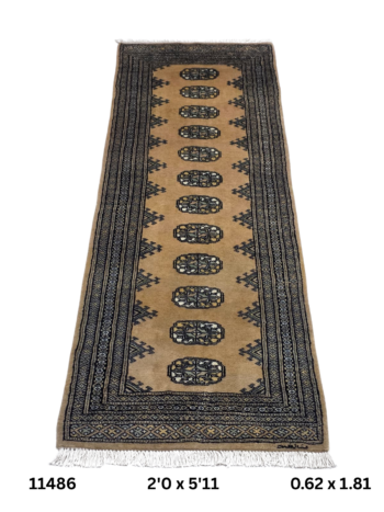 Handmade wool and cotton area rug or runner with repeated geometric Bokhara pattern displayed on floor