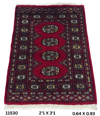 Handmade wool and cotton area rug or runner with repeated geometric Bokhara pattern displayed on floor