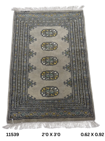 Handmade wool and cotton area rug or runner with repeated geometric Bokhara pattern displayed on floor