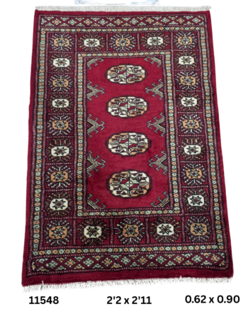 Handmade wool and cotton area rug or runner with repeated geometric Bokhara pattern displayed on floor
