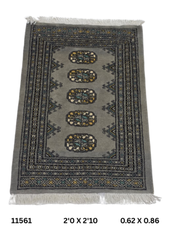 Handmade wool and cotton area rug or runner with repeated geometric Bokhara pattern displayed on floor