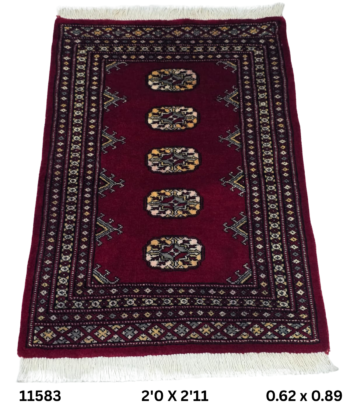 Handmade wool and cotton area rug or runner with repeated geometric Bokhara pattern displayed on floor
