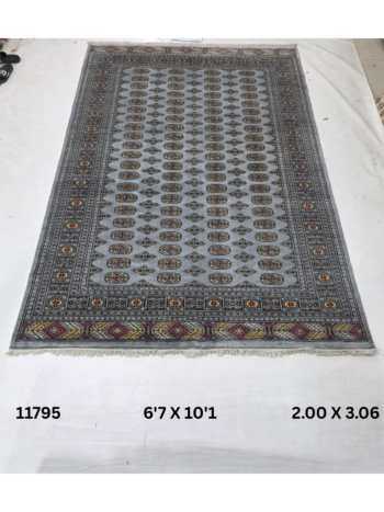 Handmade wool and cotton area rug or runner with repeated geometric Bokhara pattern displayed on floor