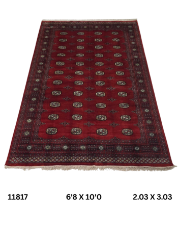 Handmade wool and cotton area rug or runner with repeated geometric Bokhara pattern displayed on floor