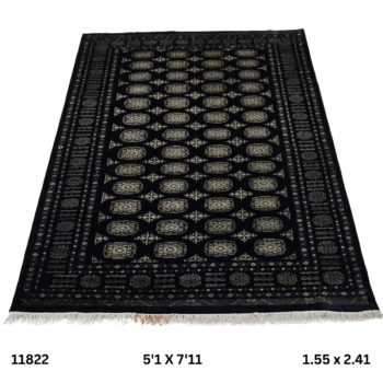 Handmade wool and cotton area rug or runner with repeated geometric Bokhara pattern displayed on floor