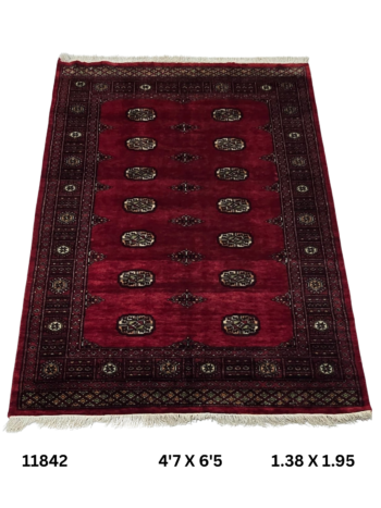 Handmade wool and cotton area rug or runner with repeated geometric Bokhara pattern displayed on floor