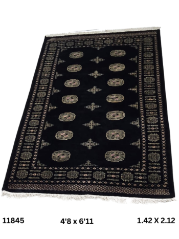 Handmade wool and cotton area rug or runner with repeated geometric Bokhara pattern displayed on floor