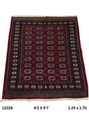 Handmade wool and cotton area rug or runner with repeated geometric Bokhara pattern displayed on floor